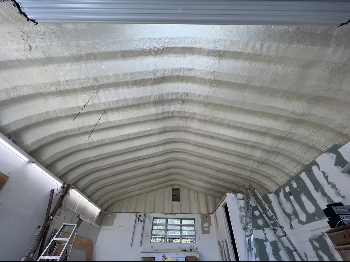 Spray polyurethane foam applied to the underside of a metal roof deck in Freeport